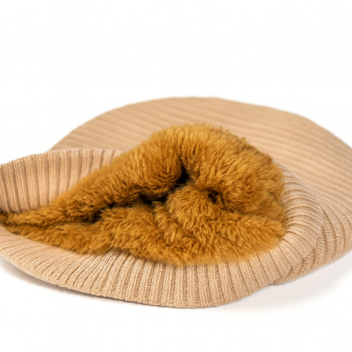 Beige knit beanie withwoolen inner photographed on a white background