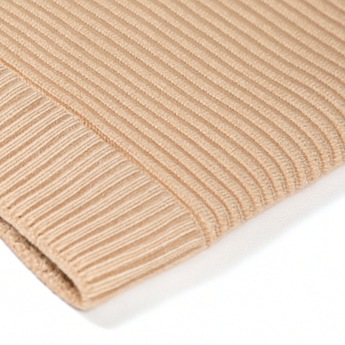 Beige knit beanie withwoolen inner photographed on a white background