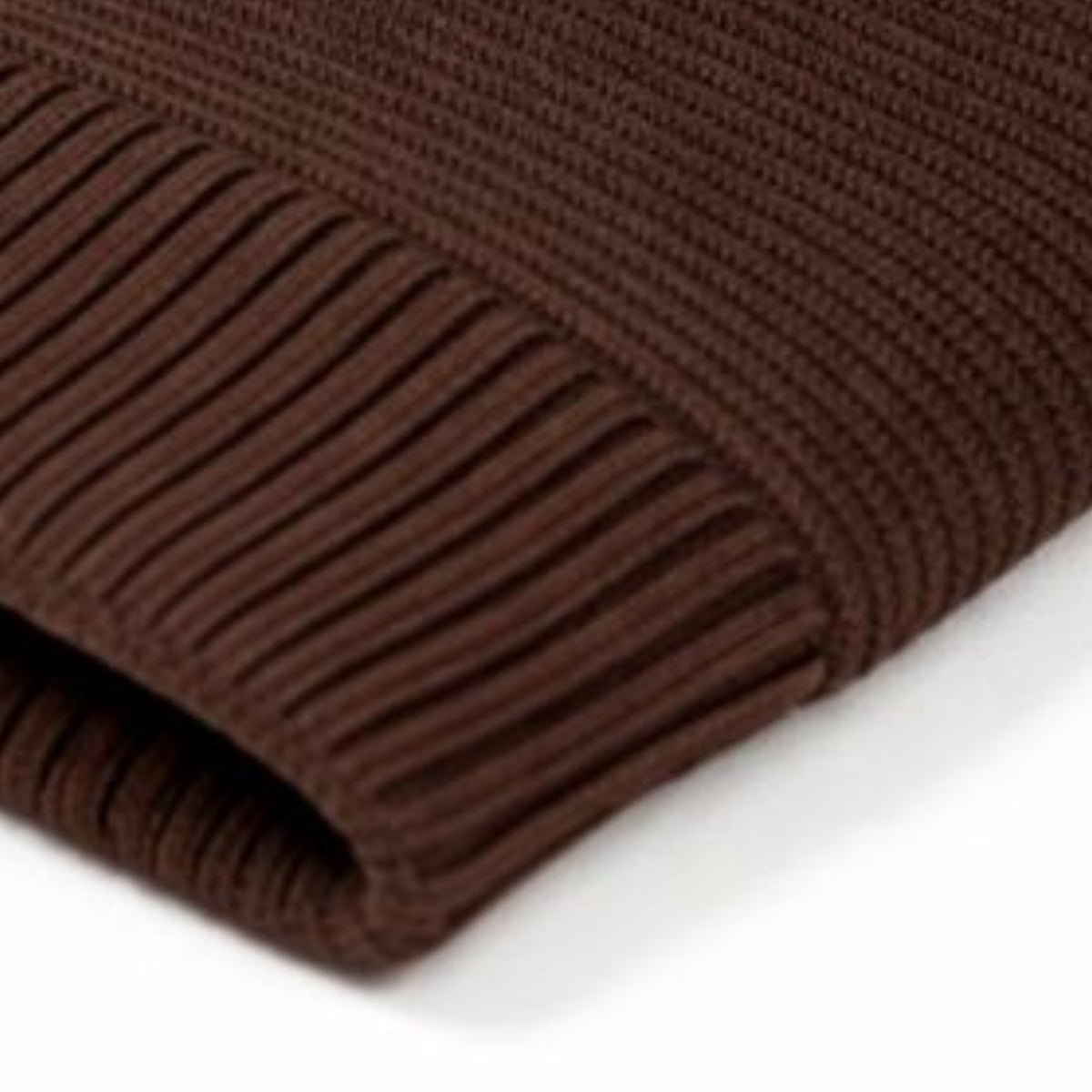 Brown knit beanie with woolen inner on a white background