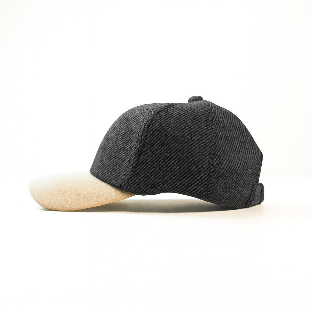 Black cap with beige visor on a white background