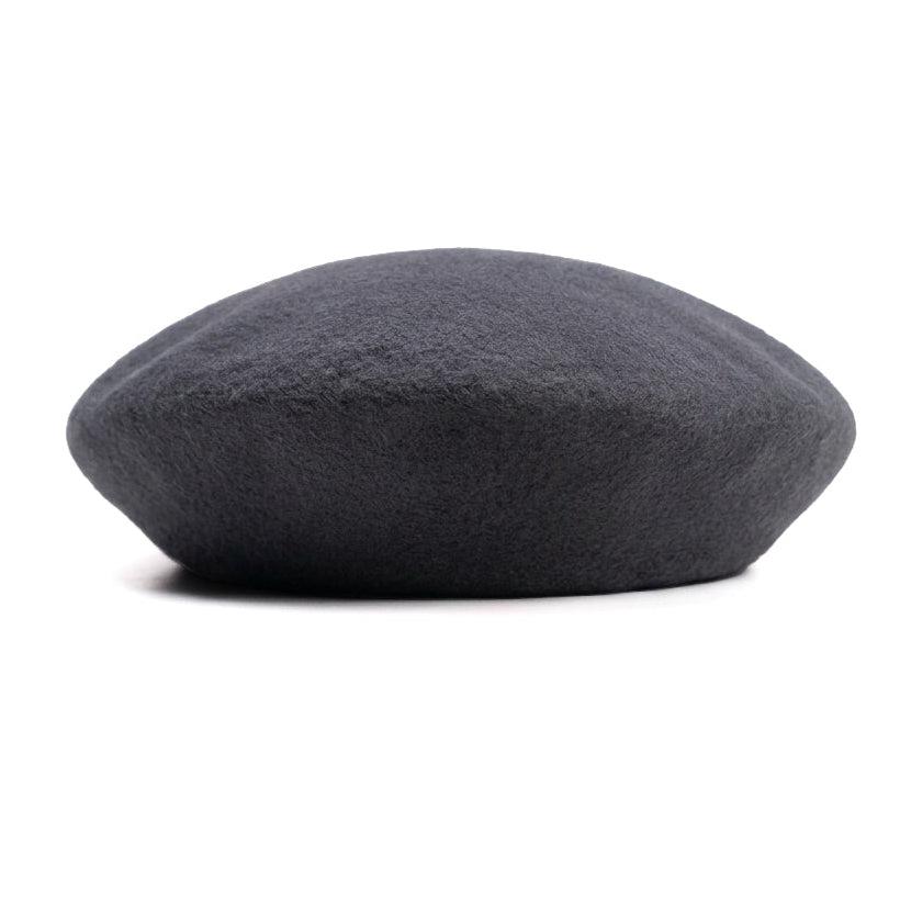 A dark charcoal gray wool beret hat, photographed from the side against a clean white background.