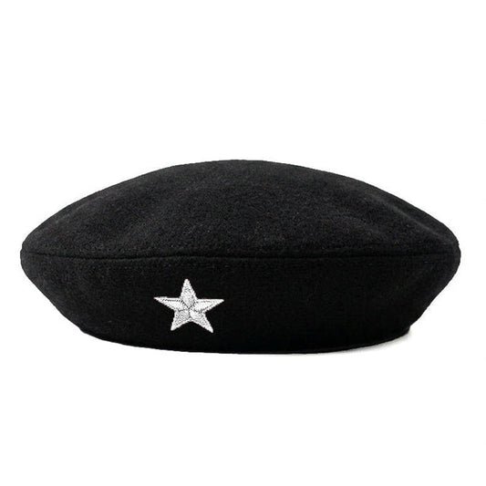 A black wool beret featuring a small, sparkling silver star embellishment on the front, set against a plain white background.