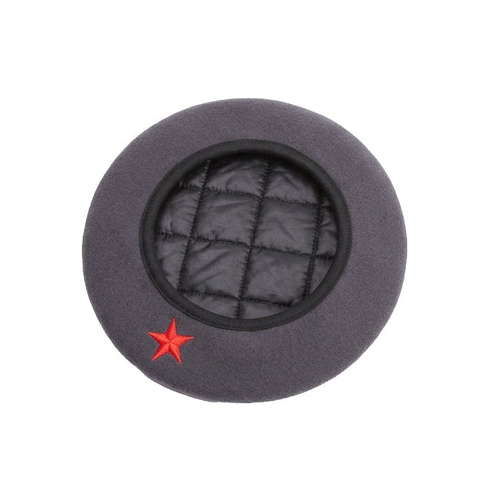 A dark gray wool beret-style hat with a black quilted padded center and a small red embroidered star on the lower left, shown against a plain white background.