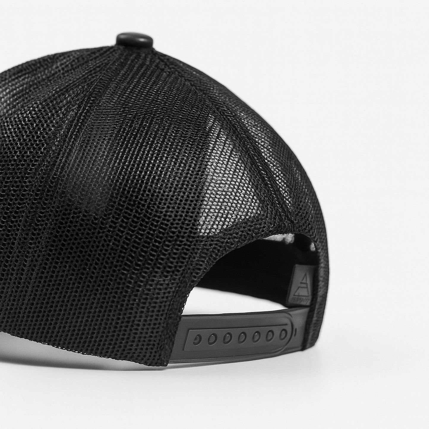 Black faux leather baseball cap with a mesh back,structured high crown , stiched curved brim and an adjustable snapback strap photographed on a white background.
