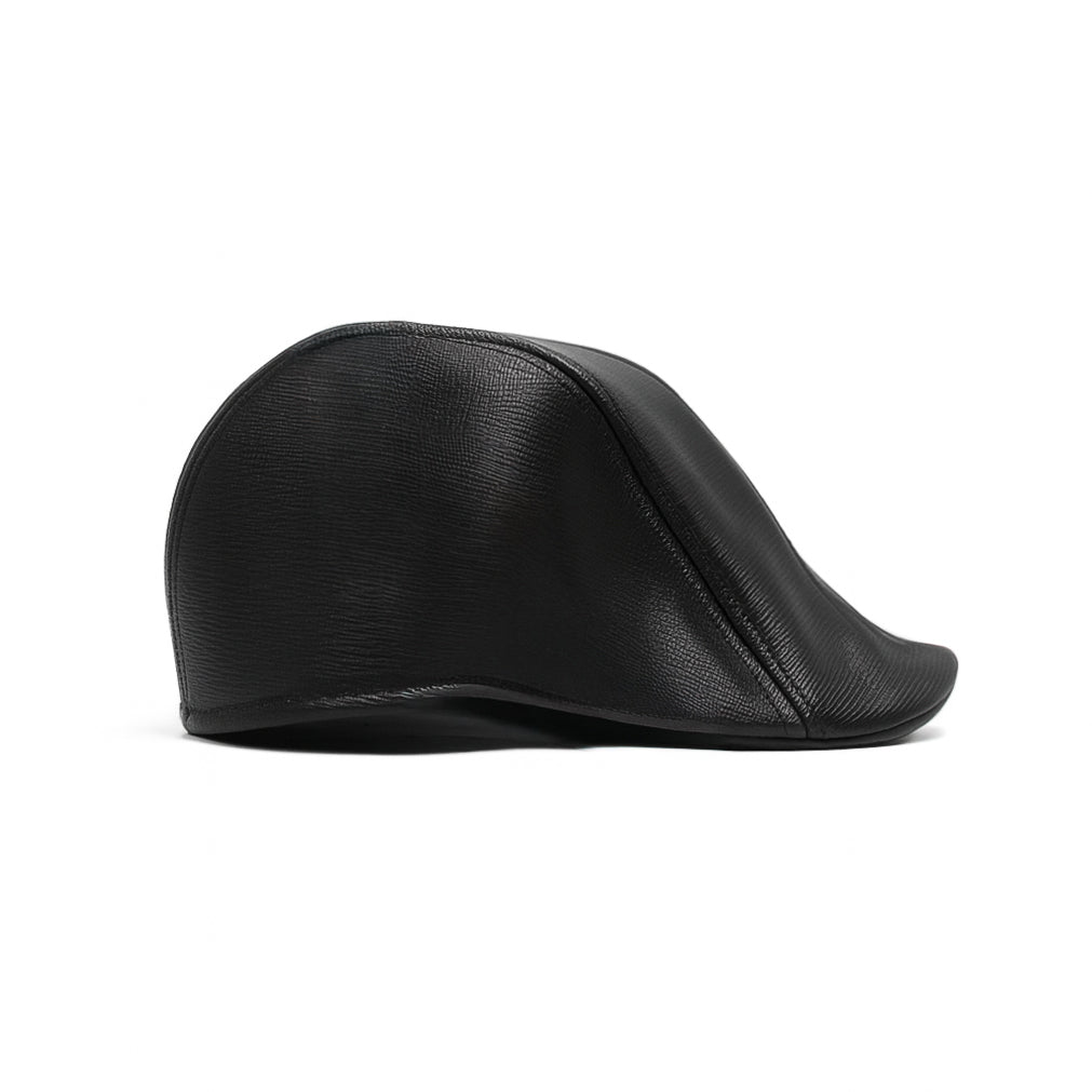 Black faux leather flat cap with a structured low crown , stiched curved in the middle and an adjustable round back photographed on a white background.

