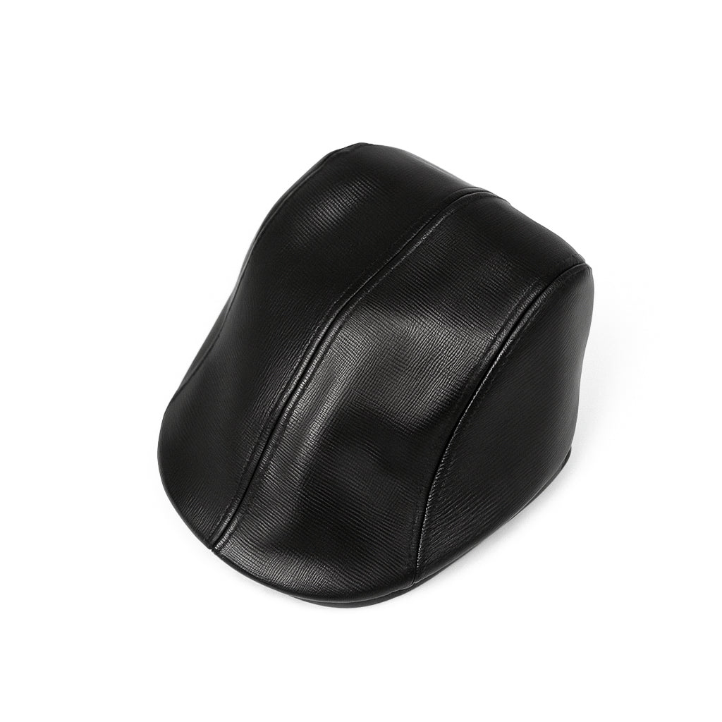 Black faux leather flat cap with a structured low crown , stiched curved in the middle and an adjustable round back photographed on a white background.

