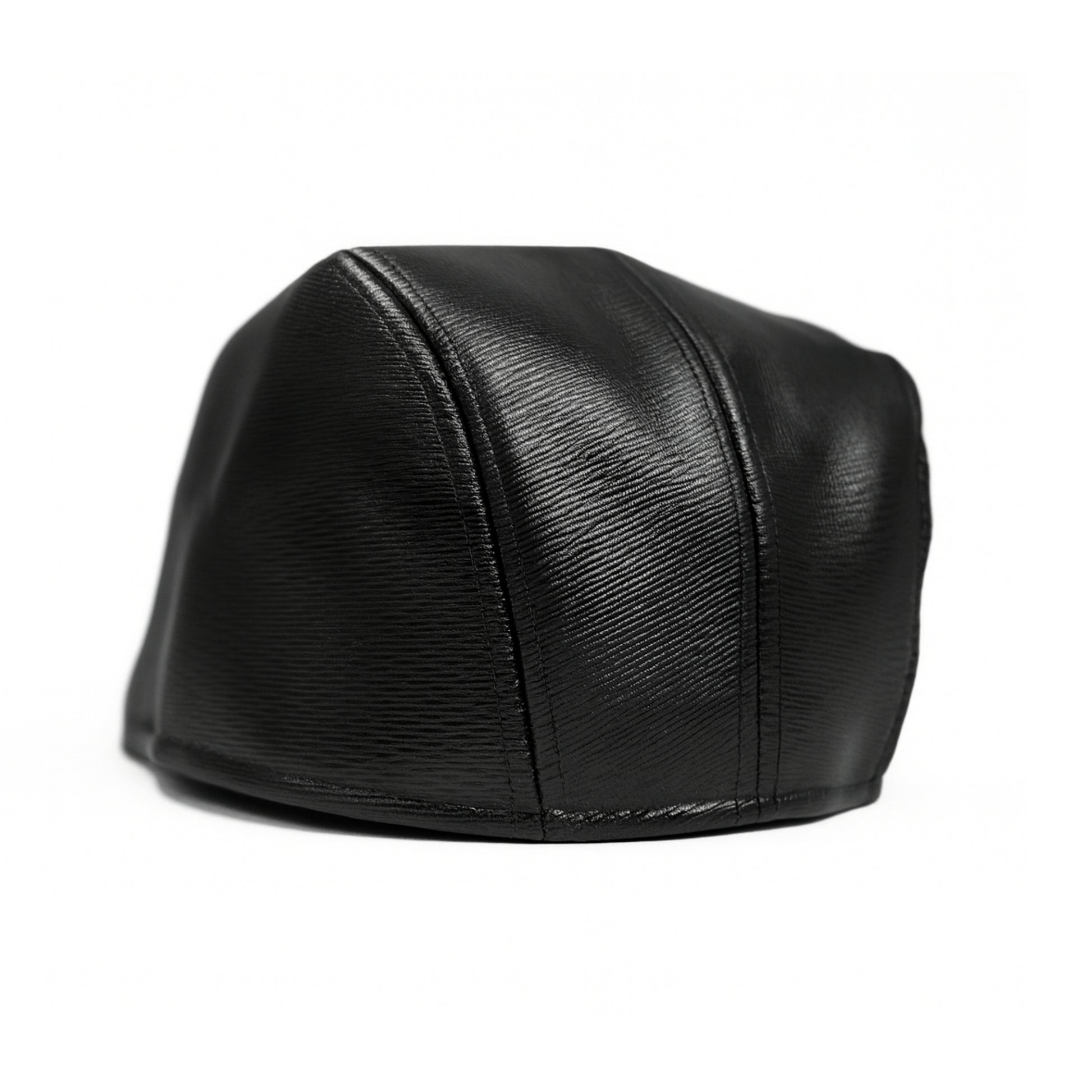 Black faux leather flat cap with a structured low crown , stiched curved in the middle and an adjustable round back photographed on a white background.
