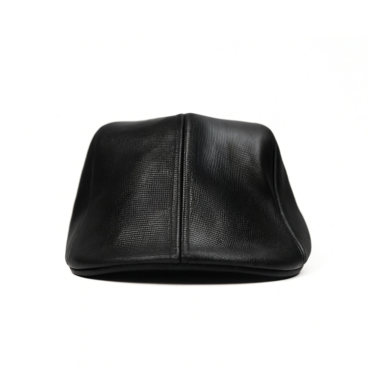 Black faux leather flat cap with a structured low crown , stiched curved in the middle and an adjustable round back photographed on a white background.
