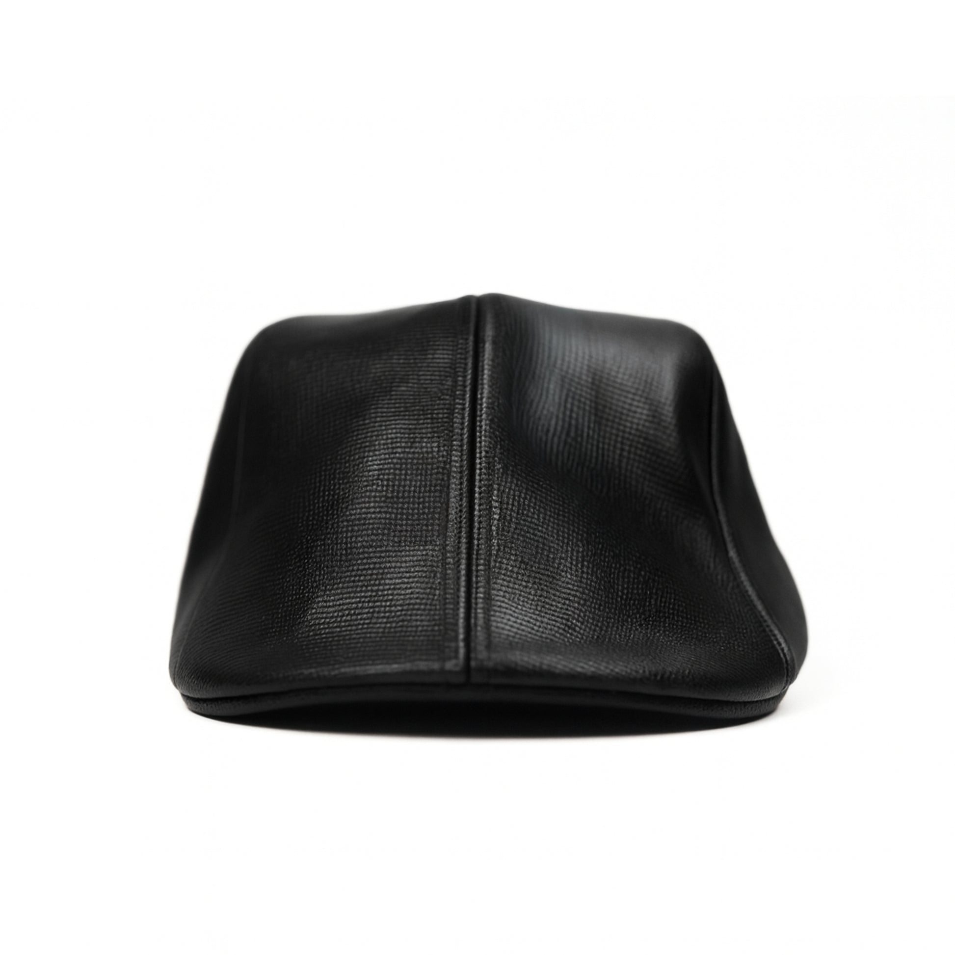 Black faux leather flat cap with a structured low crown , stiched curved in the middle and an adjustable round back photographed on a white background.
