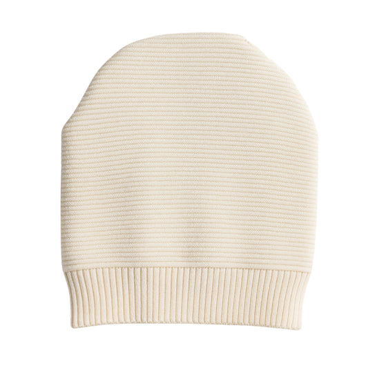 White knit beanie with woolen inner photographed on a white background