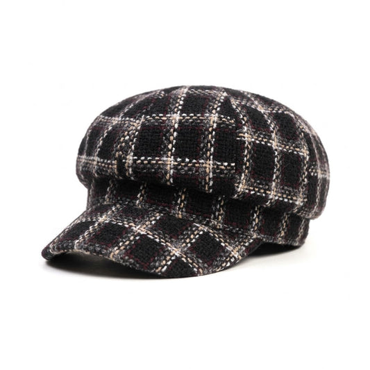 A black and white plaid newsboy cap with a structured crown and a short brim, photographed on a clean white background.
